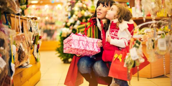 Cute Mother and Daughter Starring Something While Shopping.