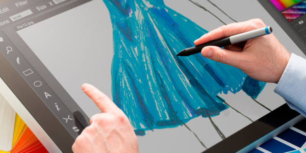 An Image Showing Fshion Designer Designing Fashion Tablet On His Tablet.